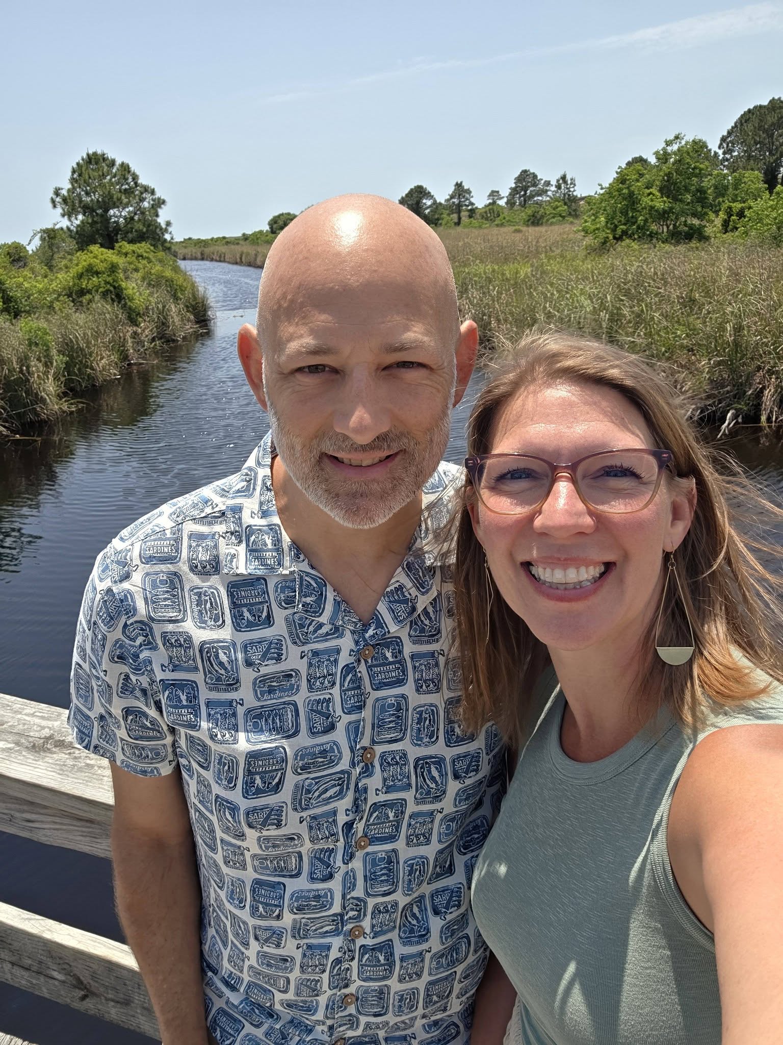 Lisa and Ryan Curran, smiling outdoors on a bright, sunny day